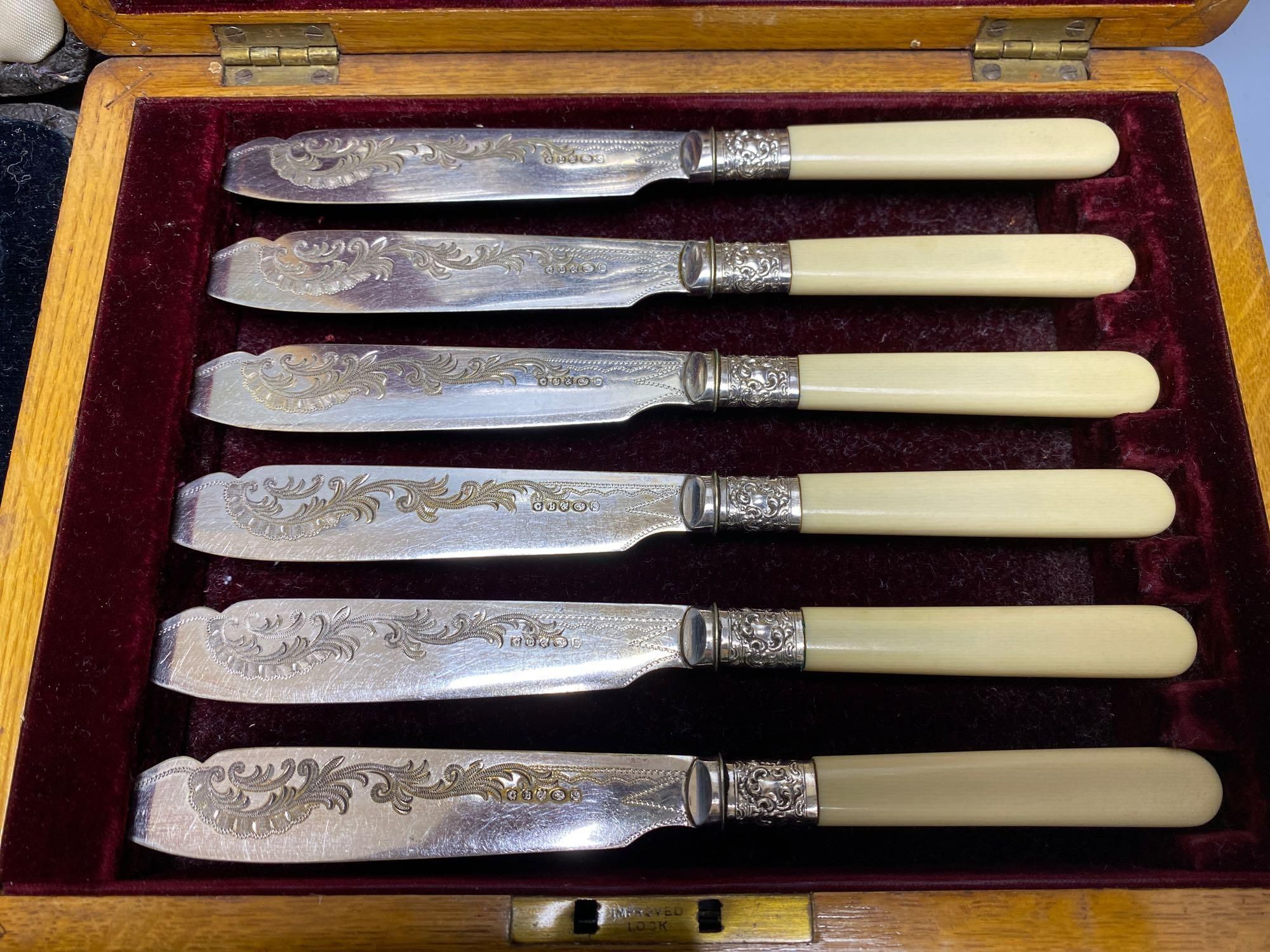 A Victorian rosewood cased set of eighteen plated dessert knives and forks, and two other cased sets of plated cutlery